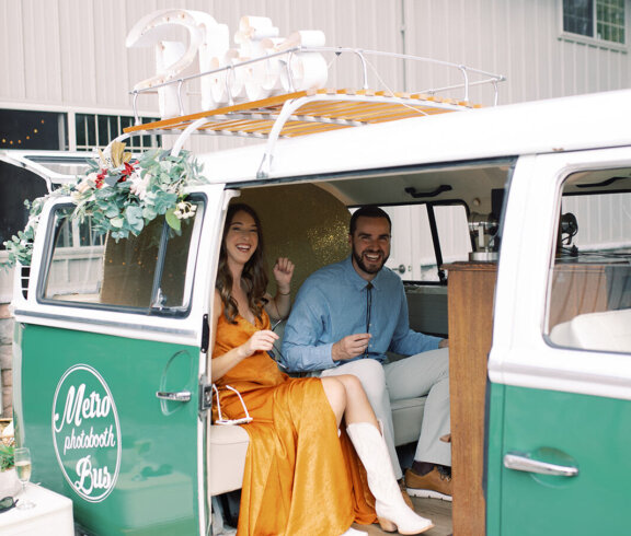 Two people attending a wedding with sitting inside a bus